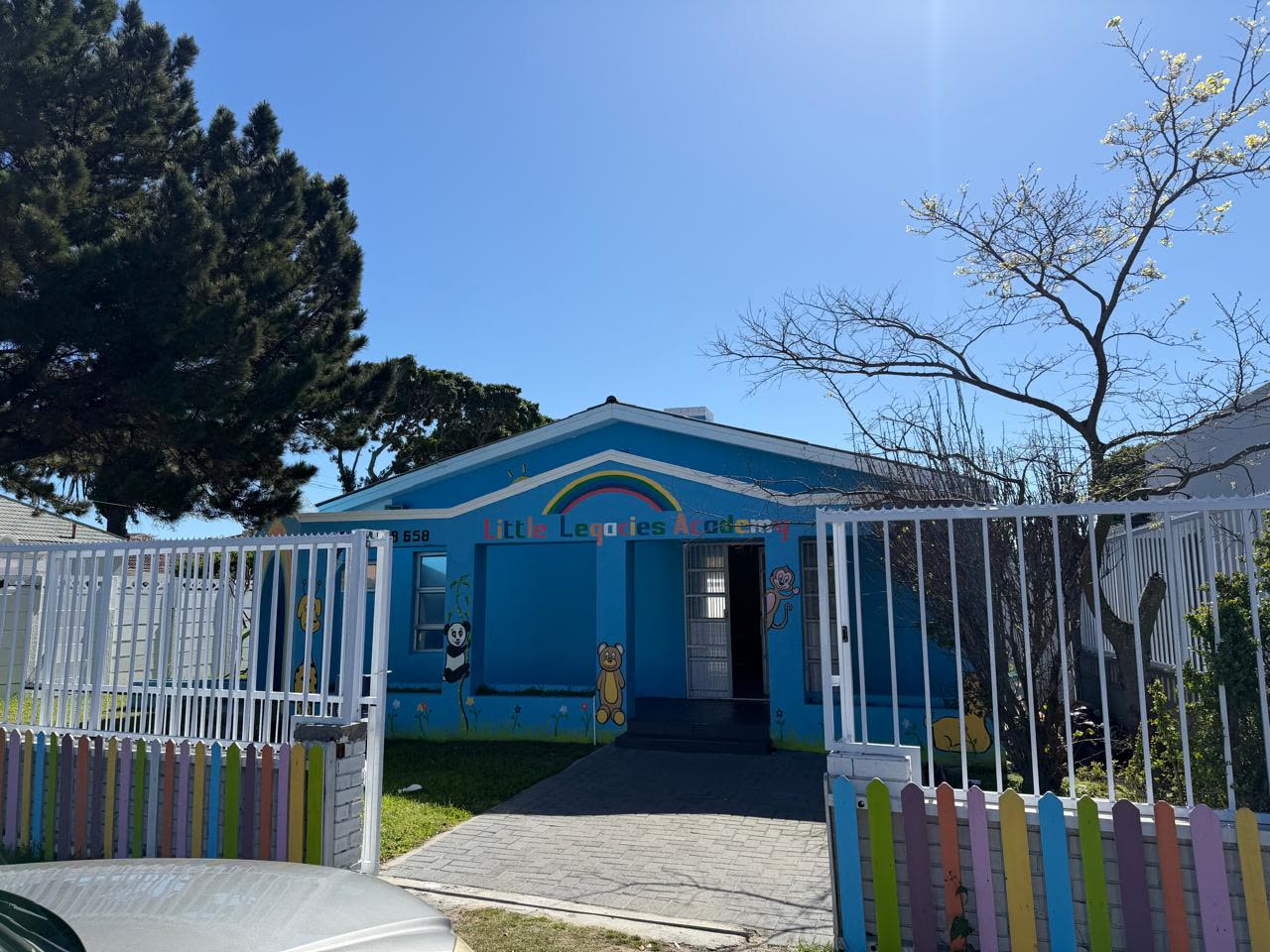 The secure front gate and paved walkway leading into Little Legacies Academy in Rondebosch East