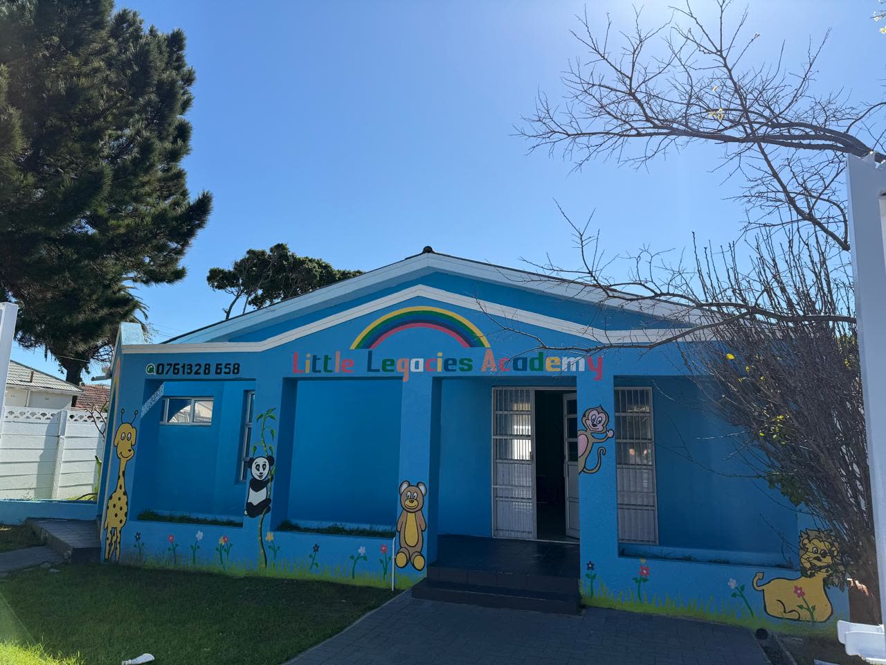 The front entrance of Little Legacies Academy on 67 Kromboom Road, Rondebosch East, painted blue with a rainbow and animal murals